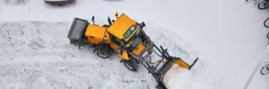 Tractor cleans a street after heavy snow.